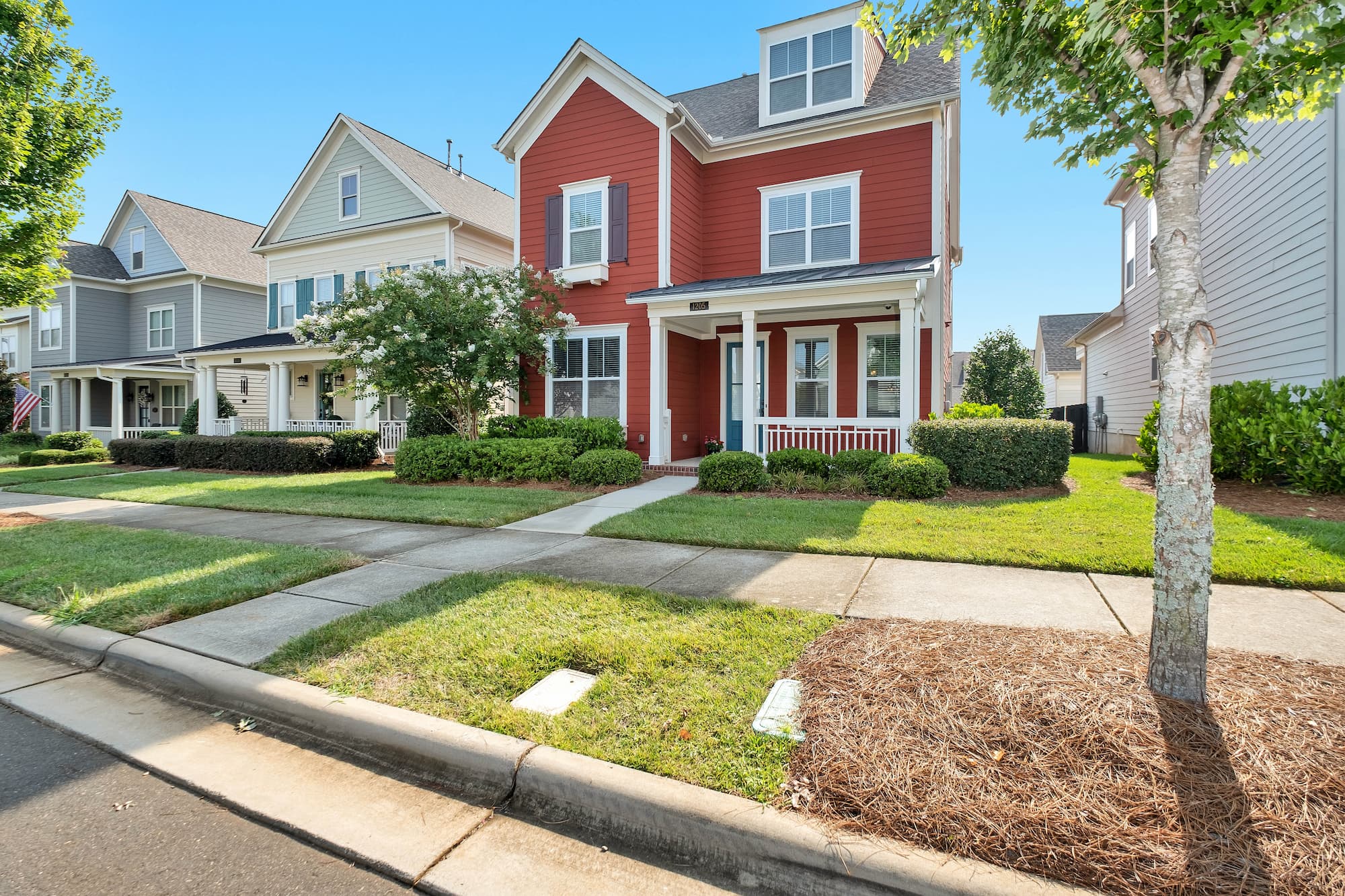 red residential home in summer
